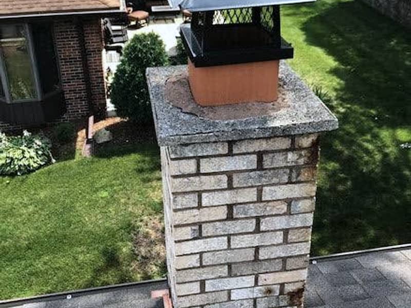 screened cap sealing the flue against nesting on a chimney in Woodbridge, NJ