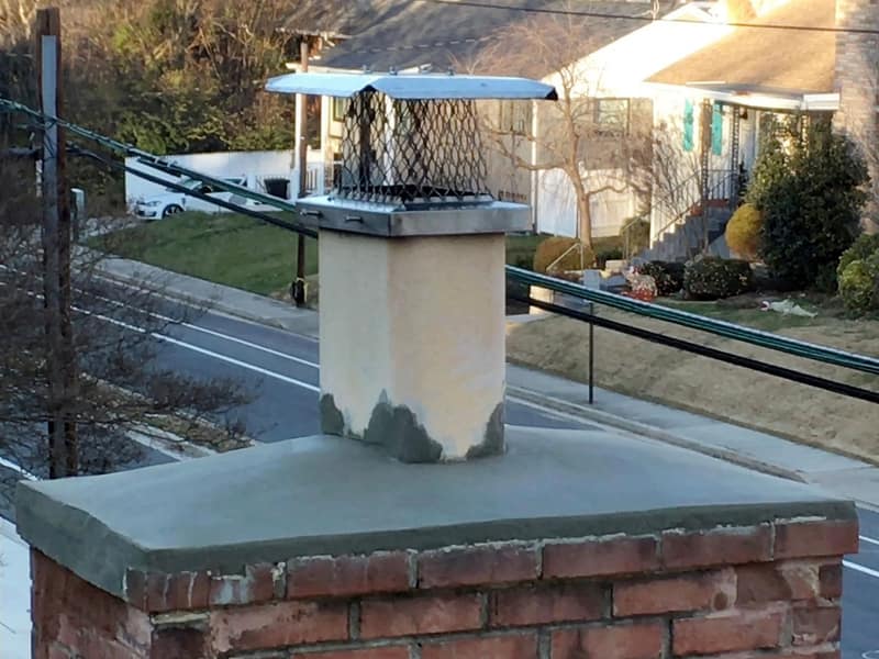 stainless mesh cap fitted over the flue on a chimney in Woodbridge, NJ