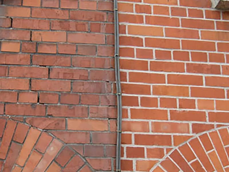 weathered brickwork beside repointed joints on a chimney in Woodbridge, NJ