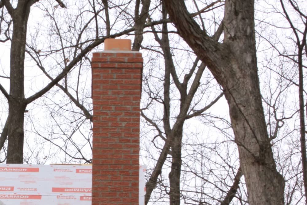Brick chimney above the roofline on a home in Edison, NJ